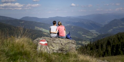 Pärchen sitzt auf einem Stein