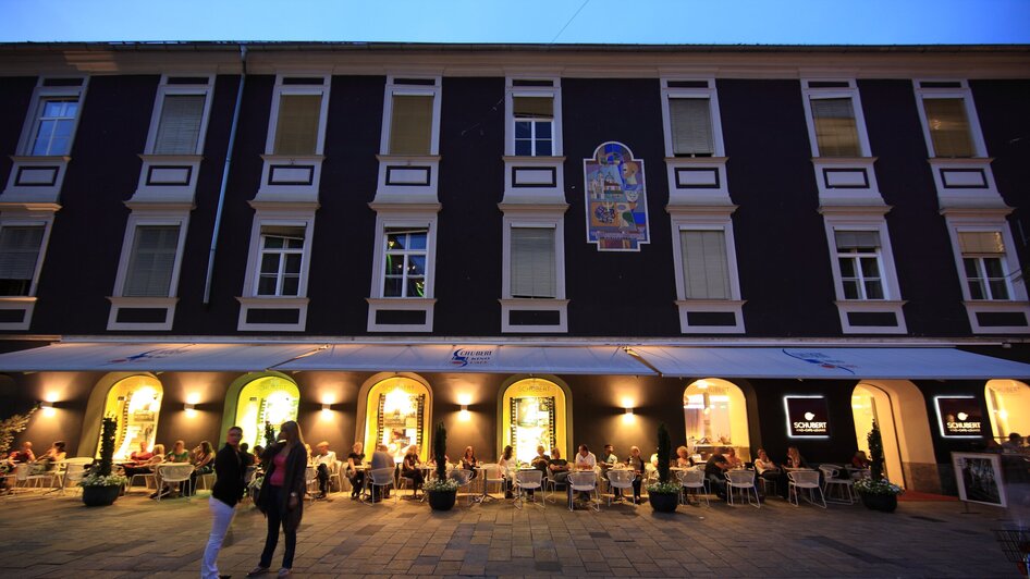 Abendliche Atmosphäre im Freien, Gäste genießen Getränke in Graz.